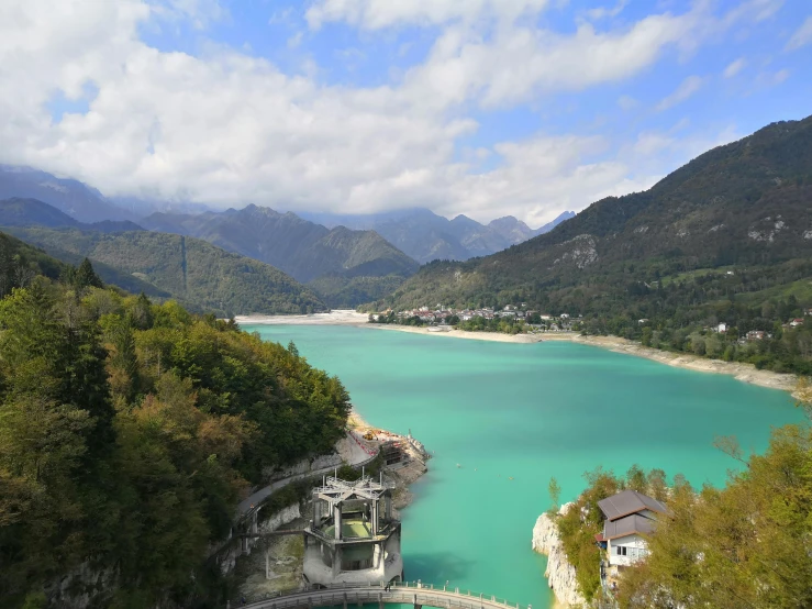 a bridge over a large body of water, inspired by Pierre Mion, pexels contest winner, hurufiyya, chartreuse and orange and cyan, mountain lakes, beautiful italian beach scene, a blond