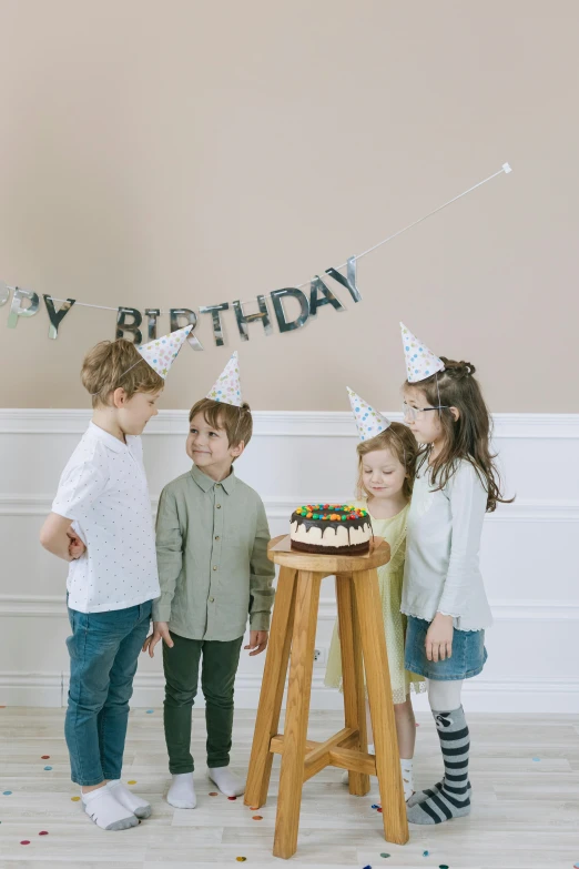 a group of children standing around a birthday cake, a picture, by Pamela Drew, pexels, decoration around the room, grey, promo image, denim
