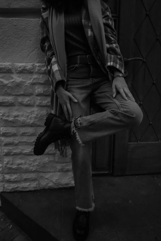 a black and white photo of a woman leaning against a wall, inspired by Dorothea Lange, unsplash, realism, wearing boots, flannel, aesthetic!!!!, ((((((((night)))))))) day time