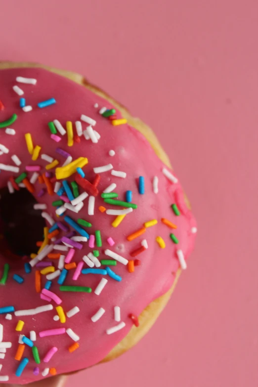 a pink donut with sprinkles on a pink surface, by Sven Erixson, pexels, 15081959 21121991 01012000 4k, video, dynamic closeup, red velvet