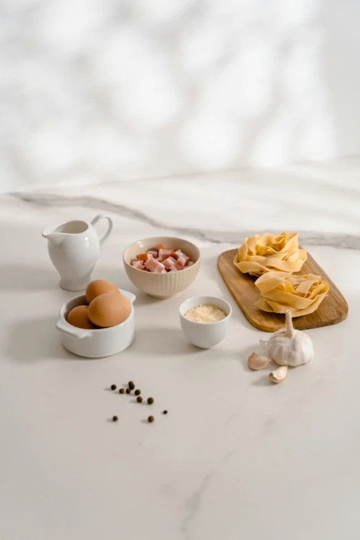 a table that has some food on it, a still life, trending on pexels, eggs, white background”, square, pasta