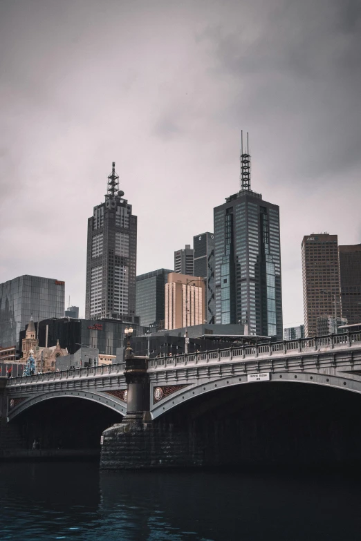 a bridge over a body of water with a city in the background, pexels contest winner, australian tonalism, elegant bridges between towers, background image, north melbourne street, tall spires