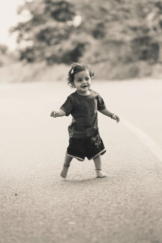 a little girl standing in the middle of a road, a black and white photo, pexels contest winner, happening, smiling and dancing, toddler, 15081959 21121991 01012000 4k, cute boy