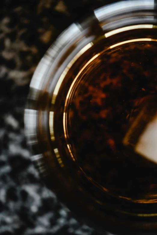 a close up of a glass of beer, a macro photograph, by Adam Marczyński, pexels contest winner, very fancy whiskey bottle, close-up from above, the sacred cup of understading, abstract detail