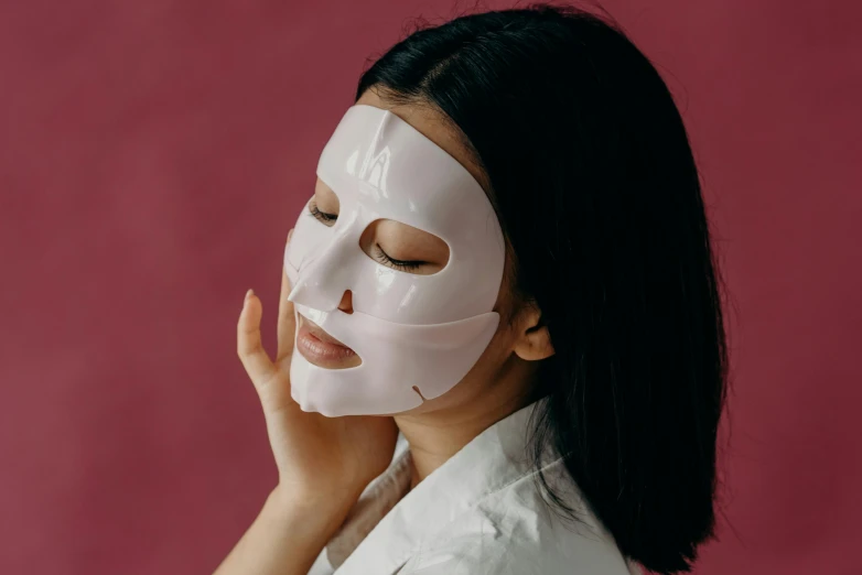 a woman with a sheet mask on her face, trending on pexels, asian women, woman is curved, frontal pose, square face