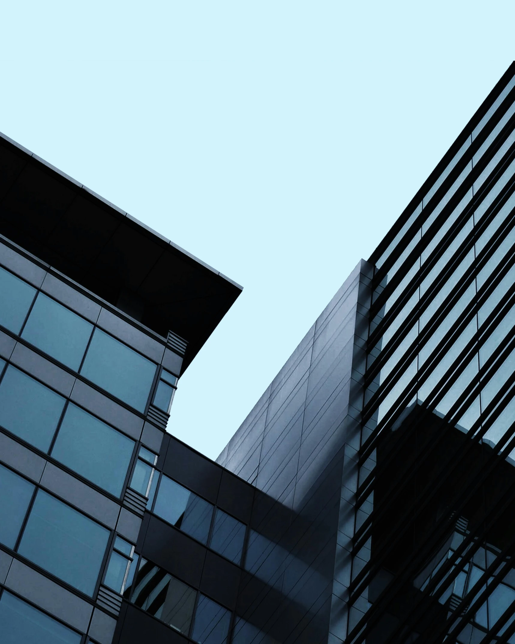 a couple of tall buildings next to each other, a screenshot, unsplash, modernism, blue and black, opaque glass, architectural photo