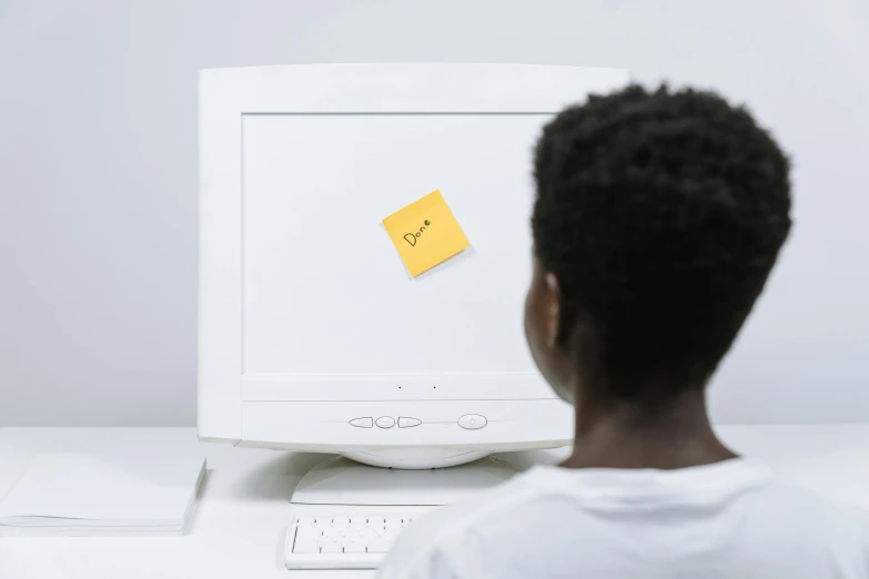 a little boy that is sitting in front of a computer, a computer rendering, pexels, ink on post it note, black teenage boy, white and yellow scheme, hidden message