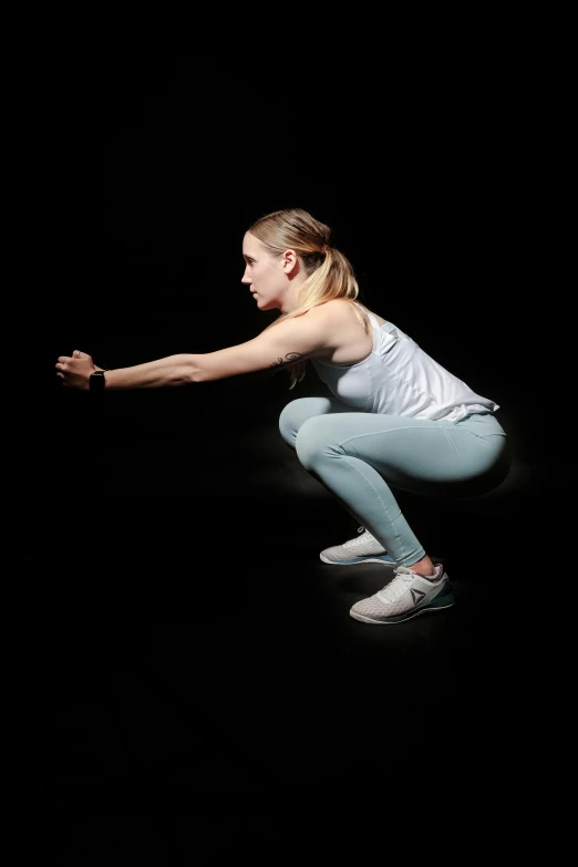 a woman squatting on a black background, biomechanics, promo image, indoor picture, mid air shot