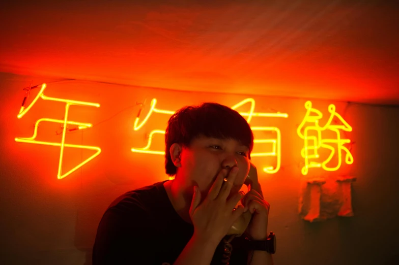 a man standing in front of a neon sign, by Gang Hui-an, tastes, orange and red lighting, li zixin, profile image
