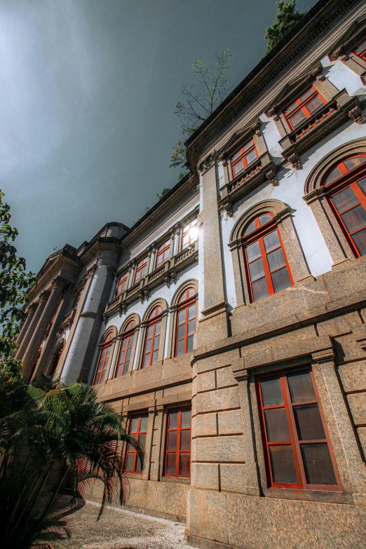 a building with a clock on the front of it, inspired by Antônio Parreiras, exterior botanical garden, grand library, grey, terracotta