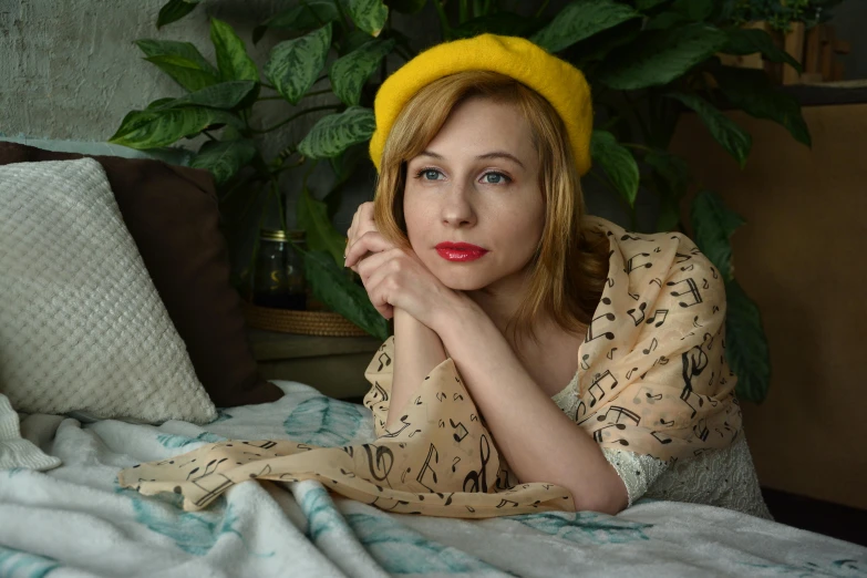 a woman laying on a bed wearing a yellow hat, an album cover, inspired by Leila Faithfull, inspired in balthus, color photograph portrait 4k, medium yellow blond hair, portrait of small