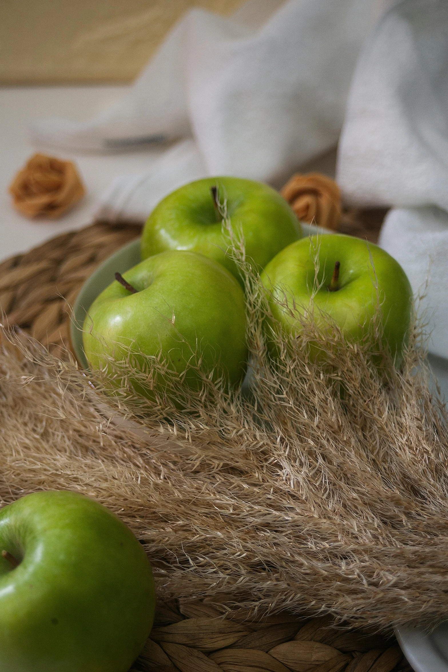 a basket filled with green apples sitting on top of a table, a still life, by Andries Stock, unsplash, grass - like, soft details, 15081959 21121991 01012000 4k