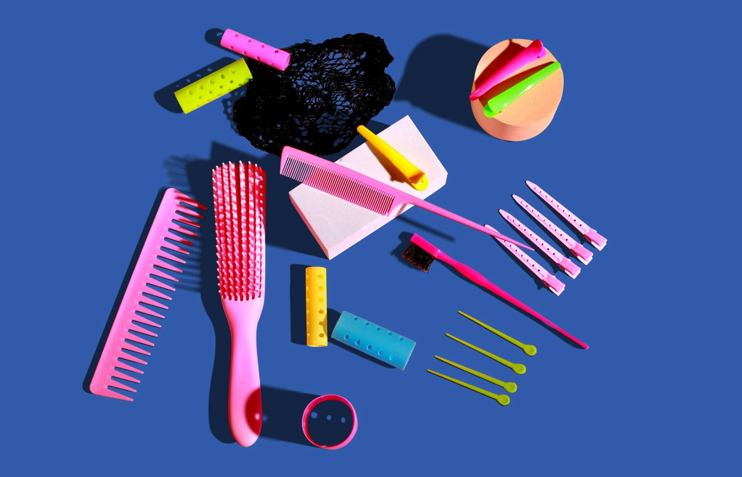 a bunch of tools sitting on top of a blue surface, a digital rendering, by Rachel Reckitt, plasticien, various hair colors and styles, dayglo pink blue, dramatic product shot, educational supplies