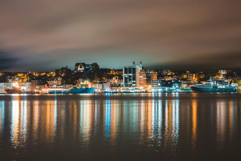 a large body of water next to a city at night, pexels contest winner, quebec, grey, brown, liege