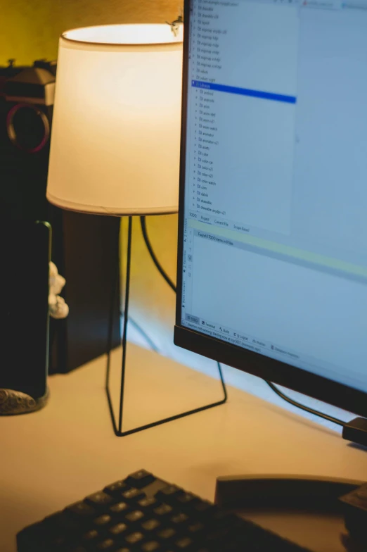 a computer monitor sitting on top of a desk, pexels, yellow lighting from right, a python programmer's despair, connectivity, organized