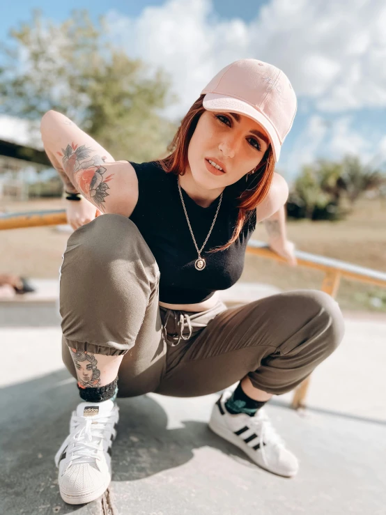 a woman sitting on top of a skateboard on a ramp, a colorized photo, inspired by Ion Andreescu, trending on pexels, wearing a baseball cap, better known as amouranth, lil peep, physical : tinyest midriff ever