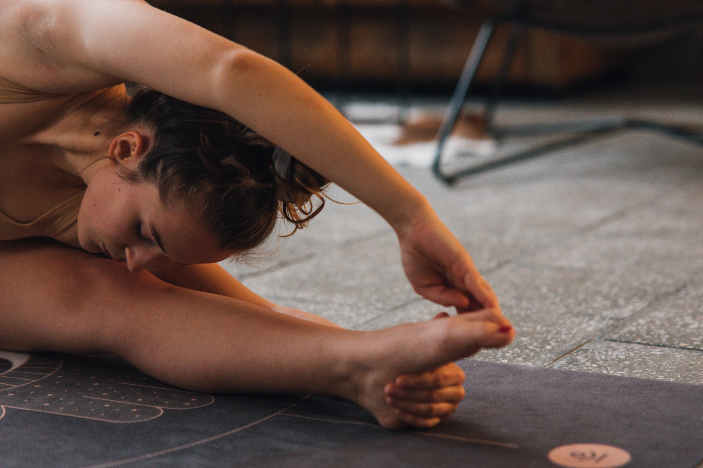 a woman doing a yoga pose on a yoga mat, a picture, by Emma Andijewska, pexels contest winner, thigh focus, as well as scratches, woamn is curved, manuka