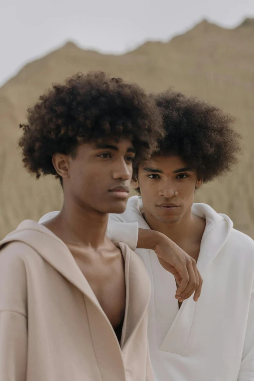 two men standing next to each other in a field, by Cosmo Alexander, trending on pexels, renaissance, imaan hammam, hair texture, boy with neutral face, modeled