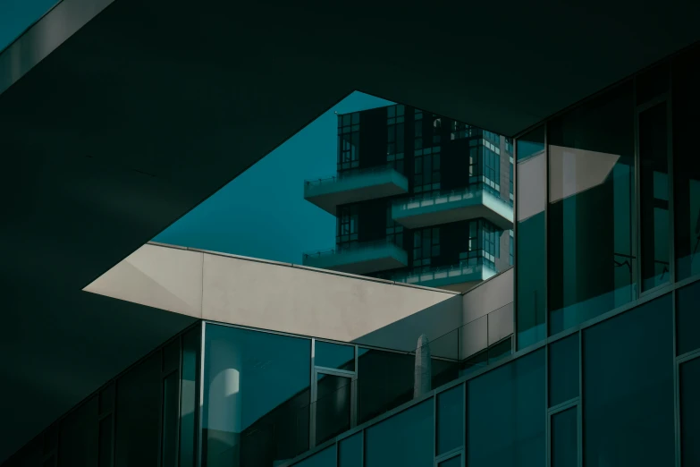 a building is reflected in the windows of another building, unsplash contest winner, modernism, black and teal paper, ignant, reflecting light, photograph taken in 2 0 2 0