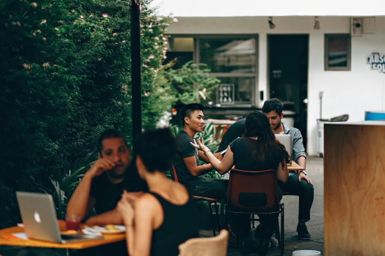 a group of people sitting around a wooden table, pexels contest winner, happening, in chippendale sydney, patio, hidden area, profile image