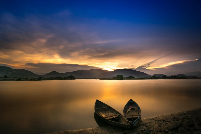 two boats sitting on the shore of a lake, by Ibrahim Kodra, unsplash contest winner, vietnam, soft glow, bright sky, lpoty