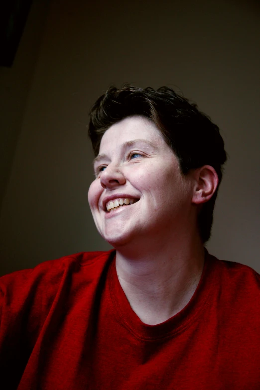 a close up of a person holding a nintendo wii controller, by Loren Munk, portrait of a smiling, non-binary, red shirt, profile image