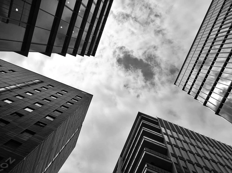 a black and white photo of tall buildings, by Adam Rex, high quality upload, fine art print, large sky, various posed