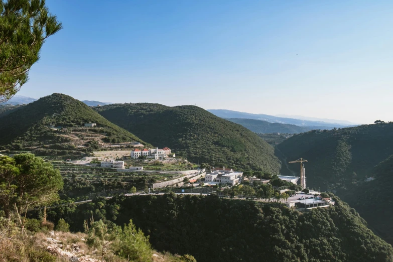 a view of a town from the top of a hill, pexels contest winner, les nabis, green valley below, dezeen, yan morala, seen from a distance