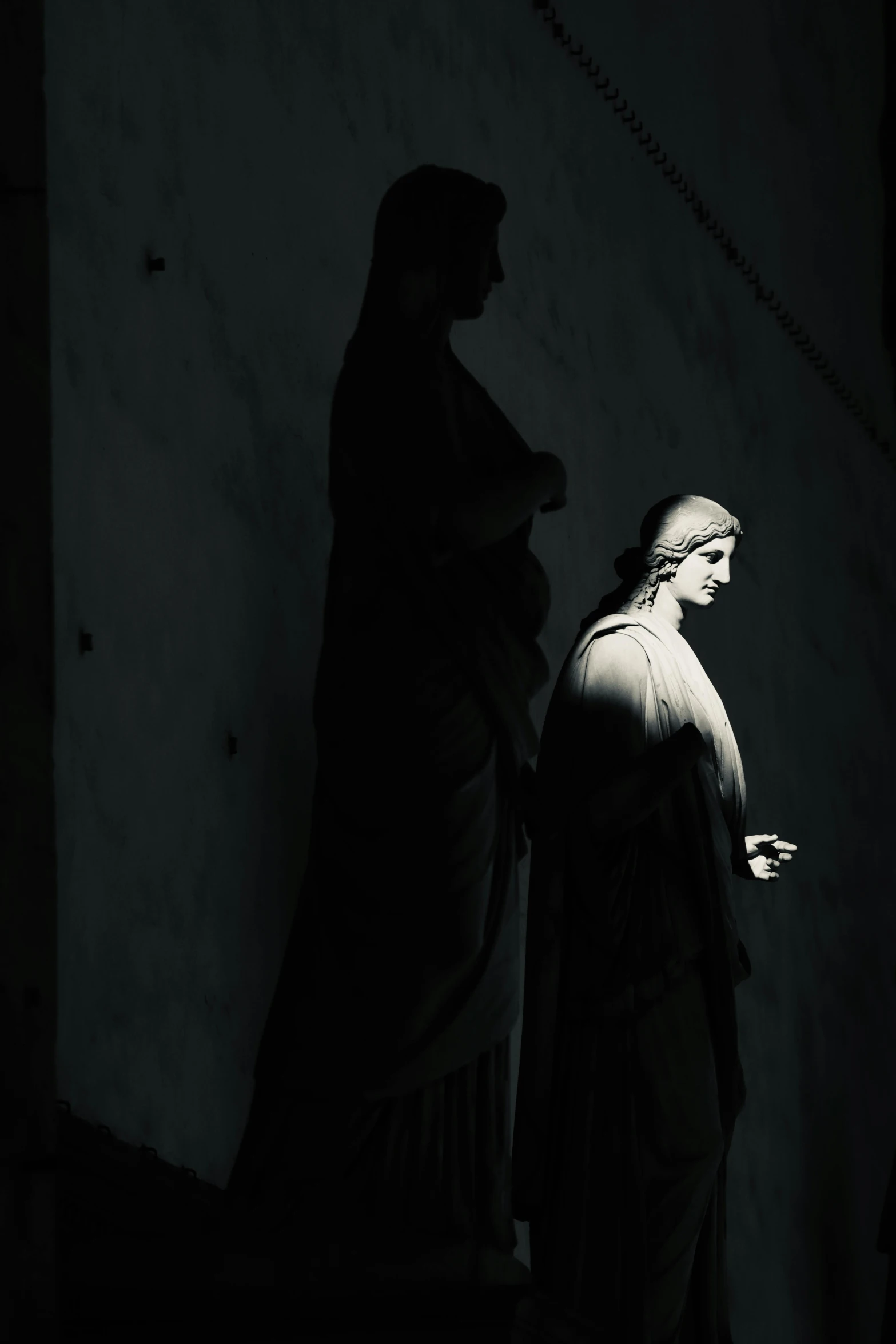 a statue of a woman standing next to a statue of a man, by Giuseppe Camuncoli, art photography, holy glow, underexposed grey, photo pinterest, rome