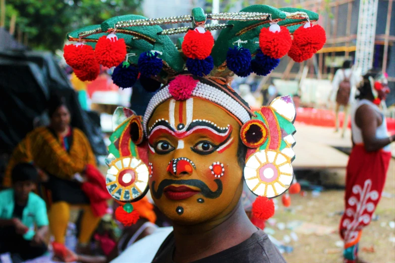 a close up of a person wearing a costume, bengal school of art, kerala village, revellers, fully decorated, profile image