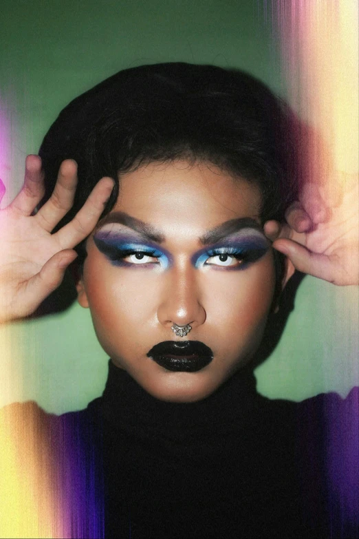 a woman is posing with her hands on her head, an album cover, inspired by Mac Conner, trending on pexels, transgressive art, demon black blue purple, attractive androgynous humanoid, black lipstick, roygbiv