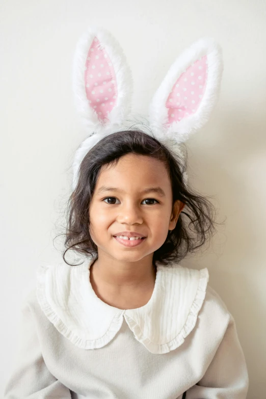 a little girl wearing bunny ears posing for a picture, a picture, full product shot, bedhead, medium, zoomed in