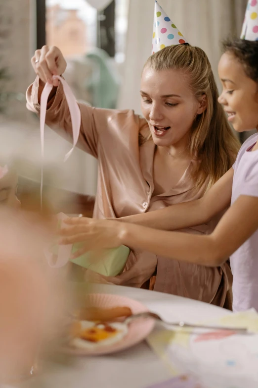 a woman and two young girls at a birthday party, pexels contest winner, happening, wide ribbons, sculpting, studio quality, gif