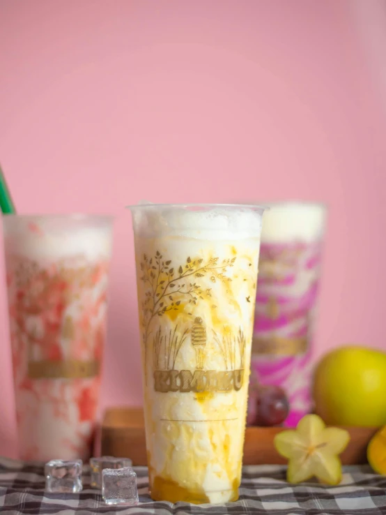 a couple of drinks sitting on top of a table, by Tan Ting-pho, process art, yellow mist, milkshake, thumbnail, seasonal