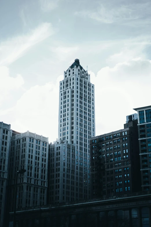 a very tall building sitting in the middle of a city, unsplash photography, white pale concrete city, chicago, 2000s photo