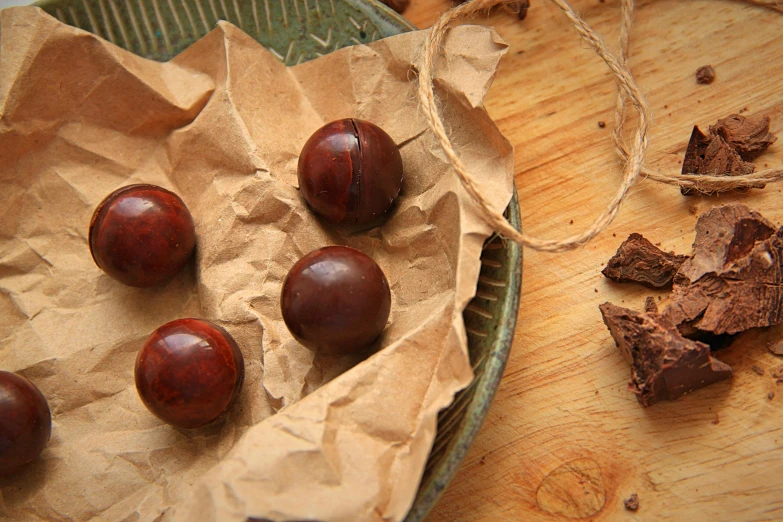 a bowl of fruit sitting on top of a wooden table, fully chocolate, fossil ornaments, thumbnail, reddish - brown