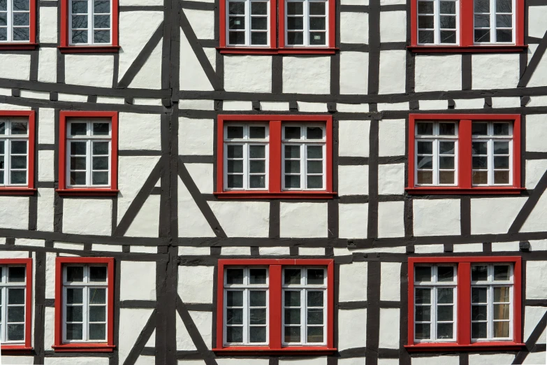 a black and white building with red windows, inspired by Matthias Jung, pexels contest winner, arts and crafts movement, detmold charles maurice, square lines, medieval house, 1 4 9 3