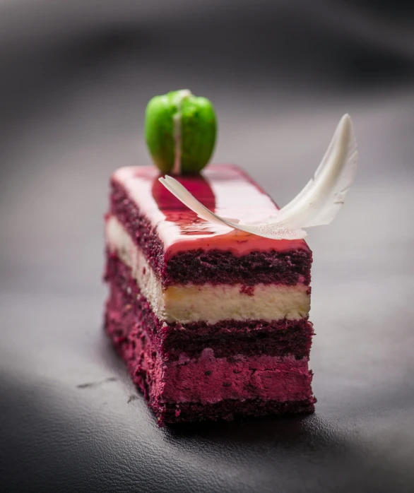 a piece of cake sitting on top of a table, pexels, exquisite and handsome wings, plum color scheme, gourmet restaurant, magenta