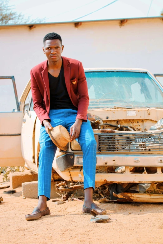 a man sitting on the hood of a car, an album cover, by Ingrida Kadaka, pexels contest winner, well - dressed, chad, crashed, official photo