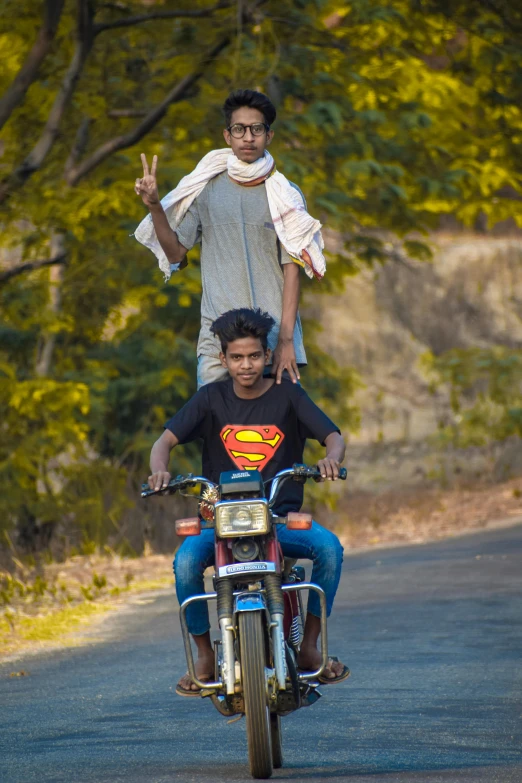 a couple of men riding on the back of a motorcycle, samikshavad, superman pose, no crop, high school, avatar image