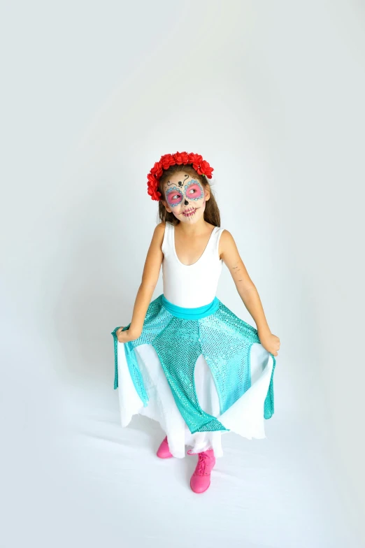 a little girl sitting on top of a white floor, inspired by Frida Kahlo, arabesque, lycra costume, white and teal garment, with a red skirt, flower mask