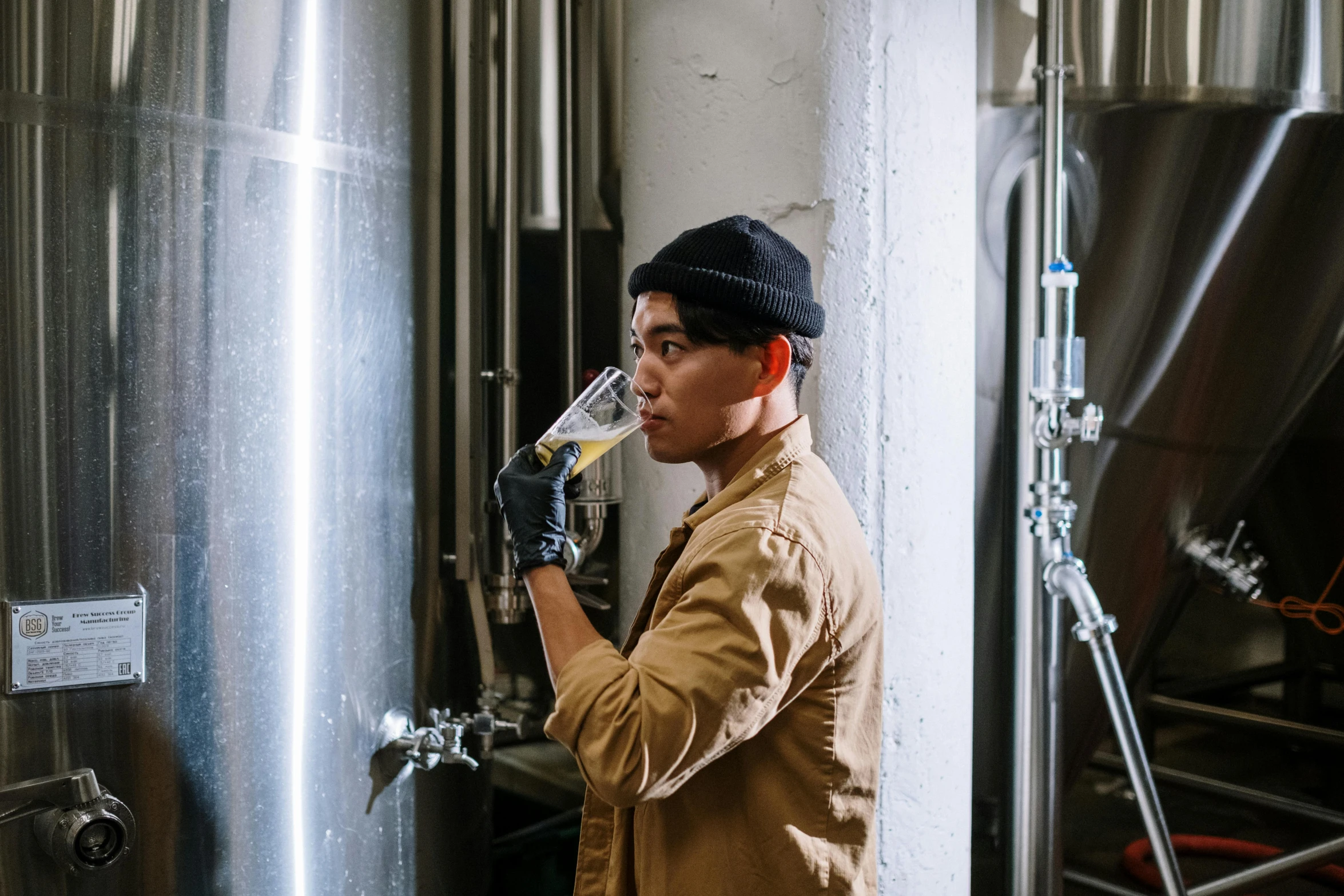 a man that is standing in front of a beer, by Tuvia Beeri, pexels contest winner, ross tan, working hard, avatar image, yeast