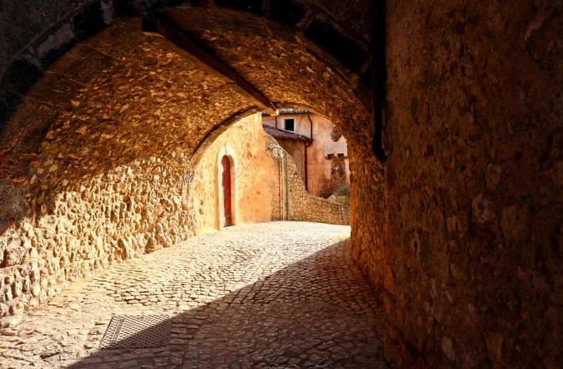 an archway in the middle of a cobblestone street, by Coppo di Marcovaldo, pexels contest winner, romanesque, golden sunlight, st cirq lapopie, thumbnail, passages