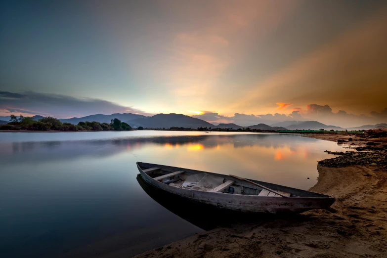 a boat sitting on top of a beach next to a body of water, pexels contest winner, romanticism, within a lake, sri lankan landscape, hangzhou, beautifully lit landscape