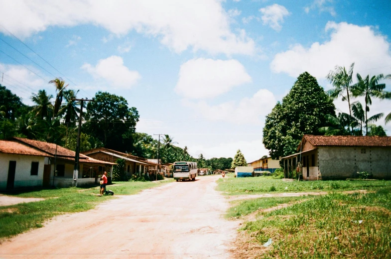 a person riding a bike down a dirt road, an album cover, unsplash, hurufiyya, view of villages, são paulo, 2000s photo, quiet beauty