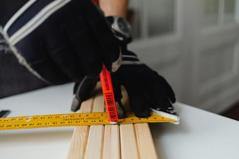 a person using a ruler to measure a piece of wood, pexels contest winner, hyperrealism, square lines, multi-part, teaser, maintenance photo