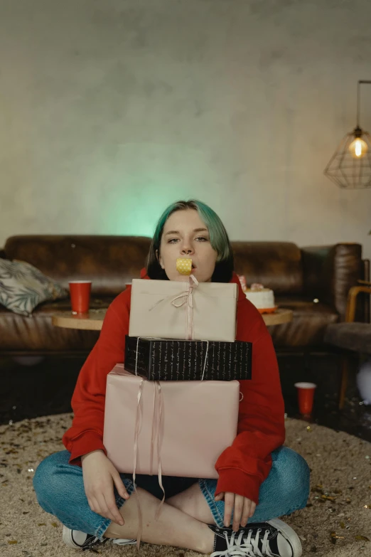 a woman sitting on the floor eating a donut, an album cover, inspired by Elsa Bleda, pexels contest winner, realism, birthday wrapped presents, billie eilish portrait, low quality footage, 4 k cinematic still