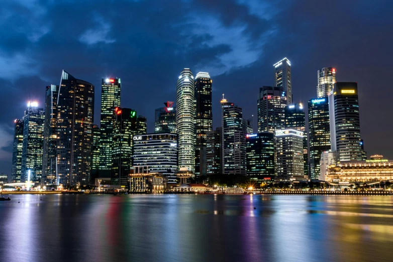 the city skyline is lit up at night, by Patrick Ching, pexels contest winner, lee kuan yew, header, profile picture 1024px, tropical coastal city