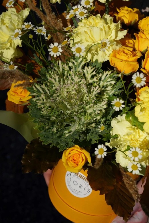 a person holding a yellow vase filled with yellow and white flowers, vanitas, dynamic closeup, extra detail, fall foliage, award - winning