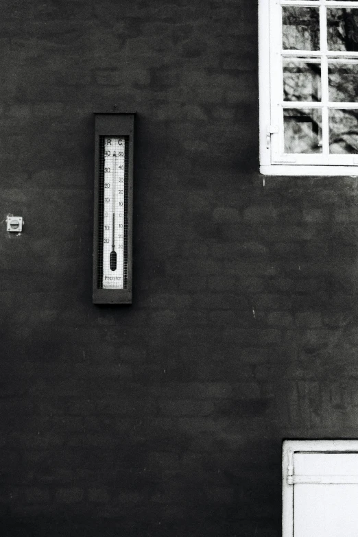 a black and white photo of a thermometer on a wall, windows and walls :5, untitled, scales, at home